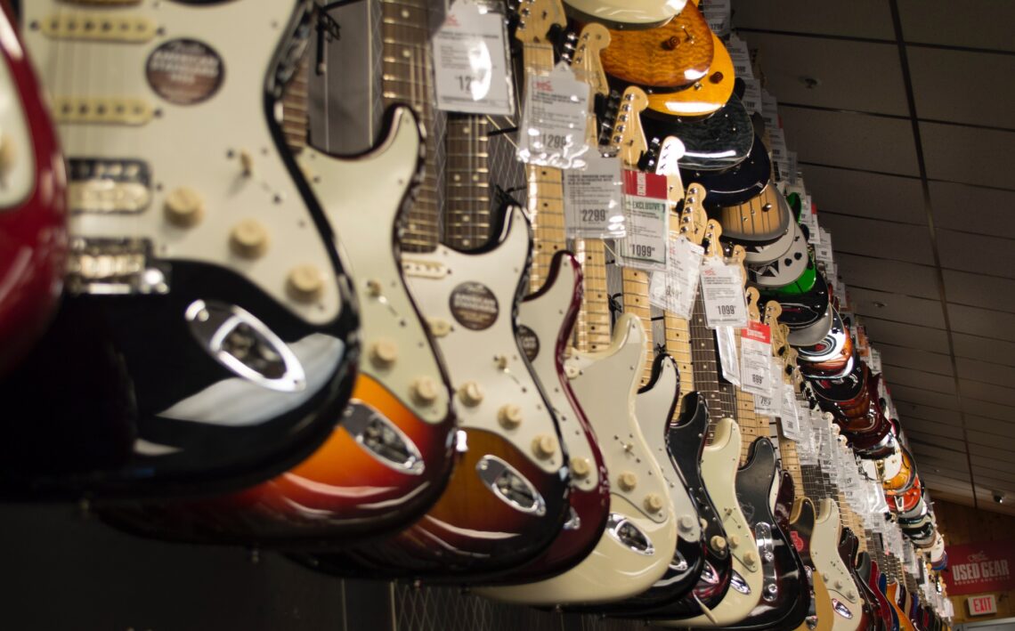 https://www.pexels.com/photo/electric-guitar-hanging-near-wall-68710/
